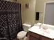 Clean and functional bathroom with a shower curtain, toilet, vanity, and stylish mirror at 4208 E Amarillo Dr, San Tan Valley, AZ 85140