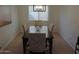 Cozy dining area with a wooden table, patterned chairs, chandelier, and bright natural light at 4208 E Amarillo Dr, San Tan Valley, AZ 85140