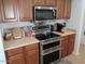 Updated kitchen featuring stainless steel appliances and warm wood cabinets at 4208 E Amarillo Dr, San Tan Valley, AZ 85140