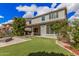 Beautiful backyard featuring an outdoor kitchen and bar, firepit, pergola, well maintained lawn, and lush landscaping at 4281 E Mesquite St, Gilbert, AZ 85296