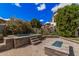 Backyard oasis with a spa, stone fire pit, lush landscaping, and beautiful pavers at 4281 E Mesquite St, Gilbert, AZ 85296