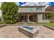 Great backyard view with a covered patio, fireplace, pavers, and lush landscaping at 4281 E Mesquite St, Gilbert, AZ 85296