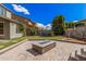 Spacious backyard featuring a stone firepit, pavers, and lush green grass perfect for entertaining at 4281 E Mesquite St, Gilbert, AZ 85296