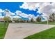 Community basketball court offers a recreational space for residents, surrounded by lush green lawns and residential houses under a blue sky at 4281 E Mesquite St, Gilbert, AZ 85296