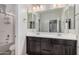 Bathroom featuring a double vanity with dark cabinets and a large mirror at 4281 E Mesquite St, Gilbert, AZ 85296