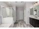 Bathroom showcases a glass-enclosed shower, a deep soaking tub, and dual vanities at 4281 E Mesquite St, Gilbert, AZ 85296