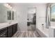 Bathroom with dual sinks and a tub with a view into the main bedroom at 4281 E Mesquite St, Gilbert, AZ 85296