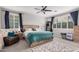 Bright bedroom with neutral tones, a cozy chair, and a large window with shutters at 4281 E Mesquite St, Gilbert, AZ 85296