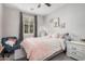 Comfortable bedroom featuring a cozy bed, accent chair, and bright natural light from the window at 4281 E Mesquite St, Gilbert, AZ 85296