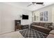 Comfortable living room with a sofa, TV, bookshelves, and a stylish geometric rug at 4281 E Mesquite St, Gilbert, AZ 85296