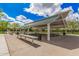 Community park pavilion with picnic tables and shady area with lush green grass around it at 4281 E Mesquite St, Gilbert, AZ 85296