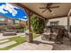 Covered patio featuring outdoor seating, a ceiling fan, and a built-in grill, perfect for entertaining at 4281 E Mesquite St, Gilbert, AZ 85296