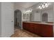 Bathroom featuring a double sink vanity, walk in closet, and neutral tile floor at 4643 E Villa Maria Dr, Phoenix, AZ 85032