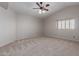 Spacious bedroom with neutral carpet, ceiling fan, and natural light at 4643 E Villa Maria Dr, Phoenix, AZ 85032