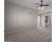 Spacious bedroom featuring neutral walls and carpet with a ceiling fan and ensuite access at 4643 E Villa Maria Dr, Phoenix, AZ 85032