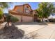 Charming two-story home with a terracotta roof and a spacious three car garage at 4643 E Villa Maria Dr, Phoenix, AZ 85032