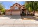 Two-story home featuring a three car garage, desert landscaping, and a beautiful terracotta roof at 4643 E Villa Maria Dr, Phoenix, AZ 85032