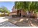 Attractive two-story home featuring a terracotta roof, three car garage, and desert landscaping at 4643 E Villa Maria Dr, Phoenix, AZ 85032