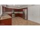 Kitchen featuring wood cabinets, stainless steel appliances, and tile flooring at 4643 E Villa Maria Dr, Phoenix, AZ 85032