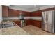 Kitchen boasts stainless steel appliances, granite countertops, and wood cabinetry at 4643 E Villa Maria Dr, Phoenix, AZ 85032