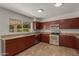 Kitchen featuring granite counters, stainless steel appliances, and tile flooring at 4643 E Villa Maria Dr, Phoenix, AZ 85032