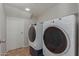 Functional laundry room featuring modern washer and dryer units, plus storage at 4643 E Villa Maria Dr, Phoenix, AZ 85032