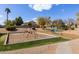 Community playground with swings, climbing structure, and wood chip ground cover for safe play at 4643 E Villa Maria Dr, Phoenix, AZ 85032