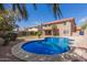 Backyard pool with a covered patio and desert landscaping, perfect for outdoor entertaining at 4643 E Villa Maria Dr, Phoenix, AZ 85032