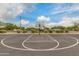 Close-up view of a basketball hoop and court in a community park setting at 4834 S Meteor --, Mesa, AZ 85212