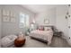 Charming bedroom with a gray bed, soft pink accents, and cozy decor, creating a serene space at 4834 S Meteor --, Mesa, AZ 85212