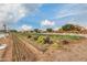 Community garden with rows of crops, surrounded by landscaping and open to residents for growing fresh produce at 4834 S Meteor --, Mesa, AZ 85212