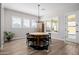 Dining room with hardwood floors and a round wood table at 4834 S Meteor --, Mesa, AZ 85212