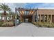 Inviting community center entrance with modern architecture, lush landscaping, and decorative accents at 4834 S Meteor --, Mesa, AZ 85212