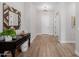 Elegant foyer with wood floors, decorative mirror, and stylish console table at 4834 S Meteor --, Mesa, AZ 85212