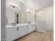 Bathroom with dual sink vanity, walk-in glass shower and wood-look tile floors at 4834 S Meteor --, Mesa, AZ 85212