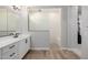 Bathroom with double vanity sinks, glass shower, and wood look tile floors at 4834 S Meteor --, Mesa, AZ 85212