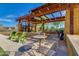 Relaxing outdoor seating area with metal furniture under a rustic pergola, perfect for community gatherings at 4834 S Meteor --, Mesa, AZ 85212