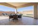 Covered patio with outdoor dining area and lounge chairs overlooks a pool, perfect for outdoor living at 4834 S Meteor --, Mesa, AZ 85212