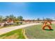 Gathering-friendly community playground featuring slides, play structures and a safe, turfed surface at 4834 S Meteor --, Mesa, AZ 85212