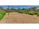 Community playground featuring a swing set and wood chip ground cover, surrounded by hedges and landscaping at 4834 S Meteor --, Mesa, AZ 85212