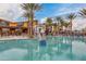 Beautiful community pool featuring a basketball hoop and plenty of lounge chairs under mature palm trees at 4834 S Meteor --, Mesa, AZ 85212