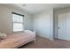 Bedroom features a bed, closet with sliding doors, and natural light from the window at 504 N Ranger Trl, Gilbert, AZ 85234