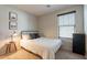 Bedroom showcasing a bed, window, side table with lamp and decor at 504 N Ranger Trl, Gilbert, AZ 85234