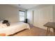 Bedroom with a bed, closet with sliding doors, window, and side table at 504 N Ranger Trl, Gilbert, AZ 85234