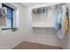 Walk-in closet with carpet flooring, shelving, and natural light from the window at 504 N Ranger Trl, Gilbert, AZ 85234