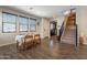 Bright dining area with a table and chairs set up near the staircase and kitchen entrance at 504 N Ranger Trl, Gilbert, AZ 85234