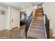 Warm entryway featuring hardwood floors, a staircase, and a view into the adjacent kitchen, creating a welcoming ambiance at 504 N Ranger Trl, Gilbert, AZ 85234