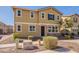 Two-story home with stucco and stone details, featuring a well-kept lawn and a pathway leading to the front door at 504 N Ranger Trl, Gilbert, AZ 85234