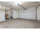 Spacious garage with water heater, metal shelving, and an automatic door, offering plenty of storage at 504 N Ranger Trl, Gilbert, AZ 85234