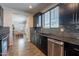 Bright kitchen with stainless steel appliances, dark wood cabinets, granite countertops, and hardwood flooring at 504 N Ranger Trl, Gilbert, AZ 85234